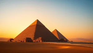 Piraminds of Giza bathed in sunset light, surrounded by desert dunes.